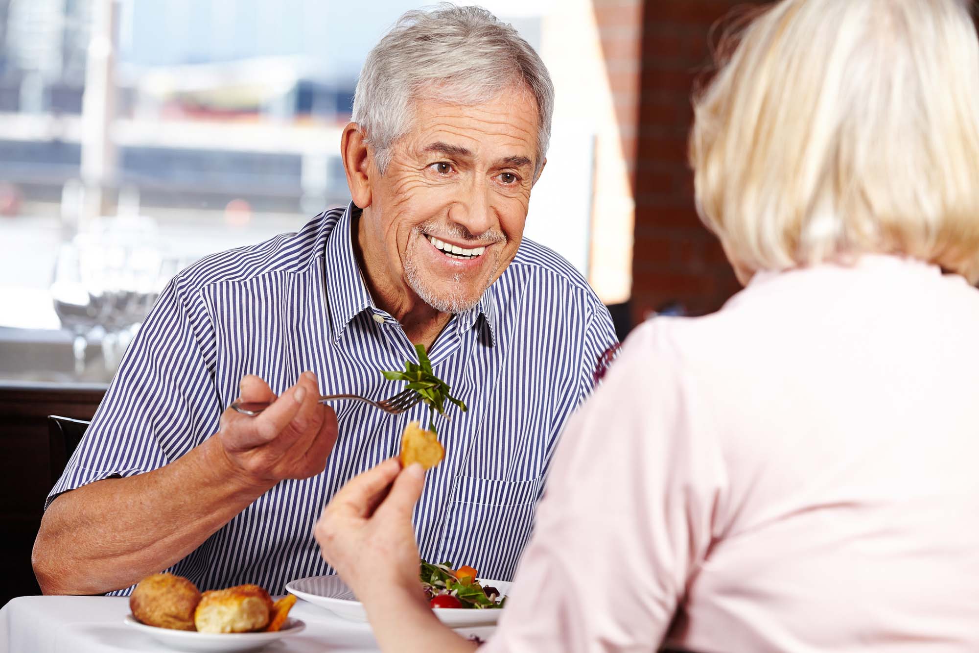 Senior couple eating in restaurant